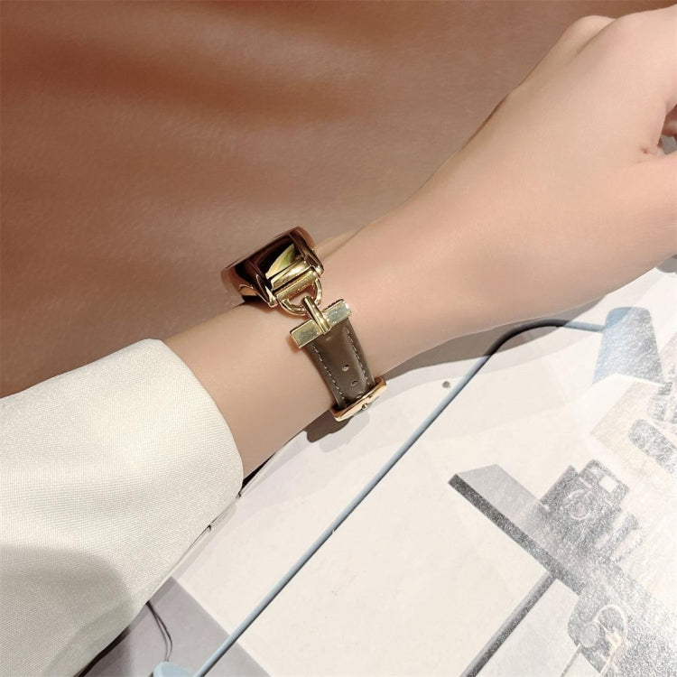 Taupe-brown genuine leather watch band with gold-tone steel D clasp on wrist