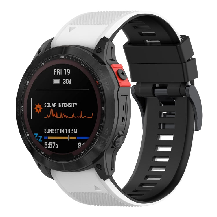 Two-tone silicone watch band on watch face, white outer and black inner strap