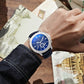 Men's quartz business watch with blue dial, silver case, and dark leather strap
