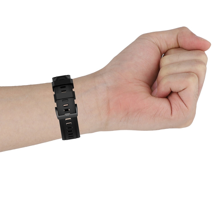 20mm textured silicone watch strap on wrist, black with plastic quick-release clasp