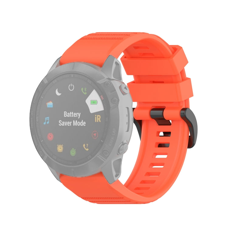 Textured quick-release wrist strap with plastic button, bright orange band.