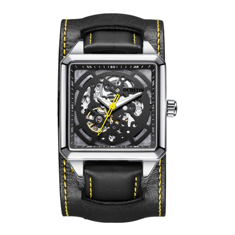 Silver skeleton mechanical watch with black leather strap and yellow stitching, front view