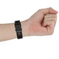 Black 22mm textured watch strap with plastic quick-release buckle, wrist side view