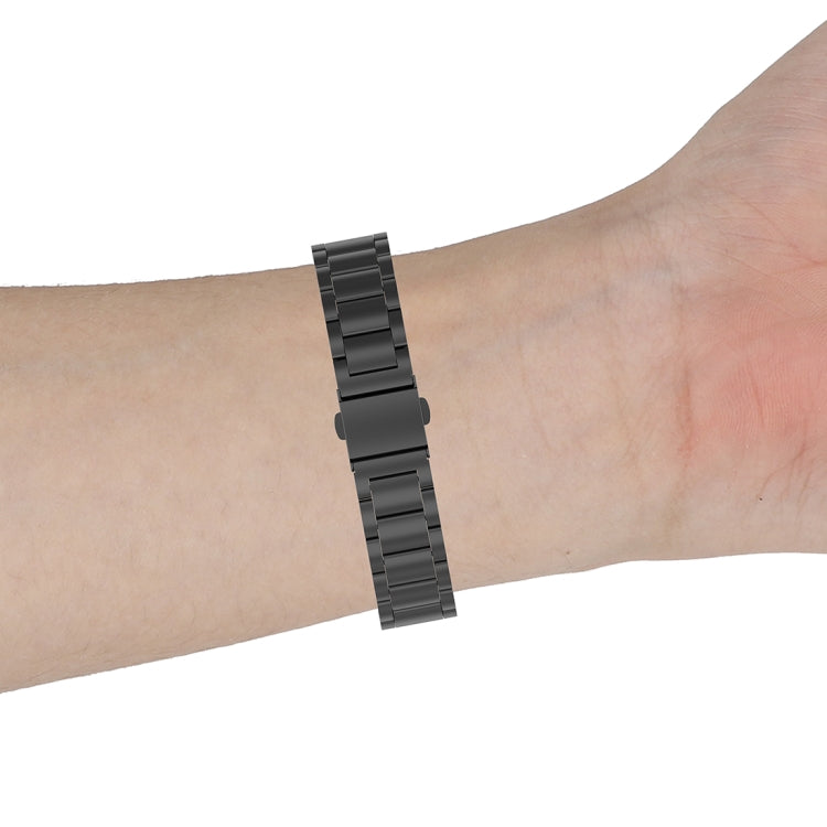 Black three-bead metal watch strap on wrist
