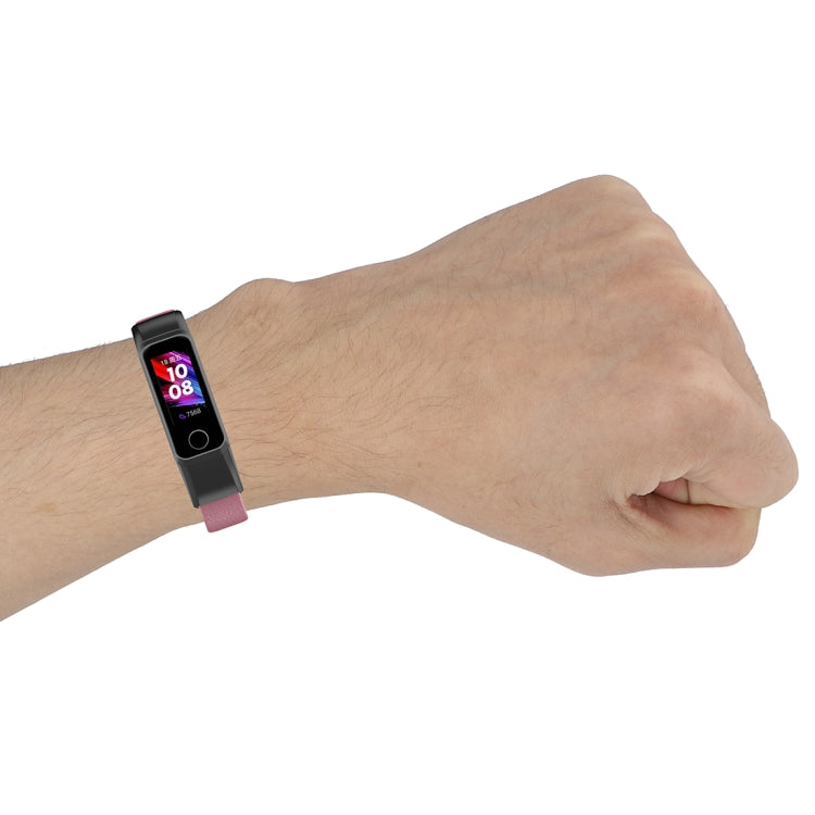 Pink leather watch strap with fitness tracker on wrist, silver buckle visible