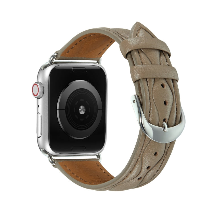 Leather Apple Watch strap in light taupe with brown underside and metal clasp.