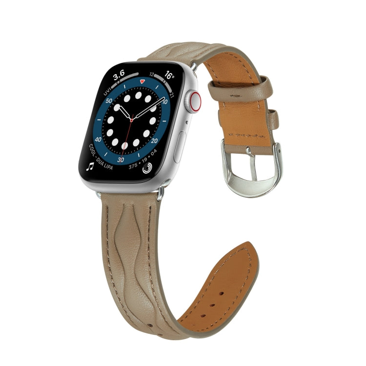 Taupe leather Apple Watch strap with brown underside and metal buckle hardware.