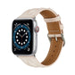 Cream leather Apple Watch strap with beige underside and metal buckle.