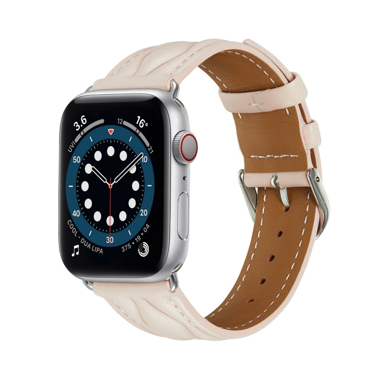 Cream leather Apple Watch strap with beige underside and metal buckle.