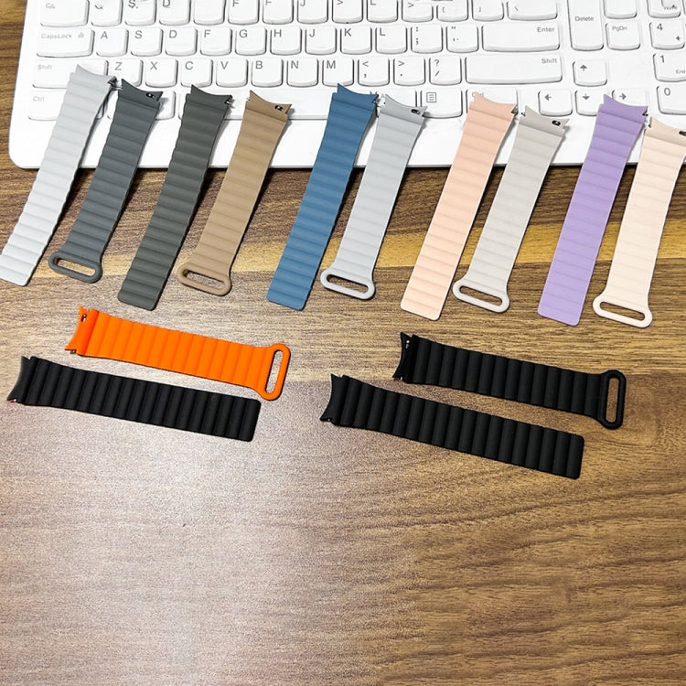 Assorted silicone magnetic watch bands laid out on a desk