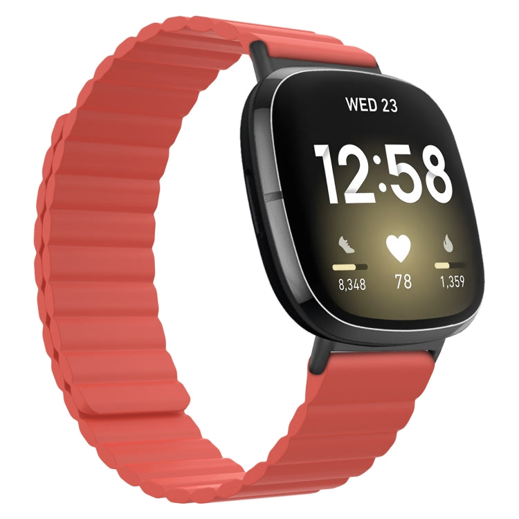 Coral red silicone magnetic watch band with ridged strap and black clasp end.