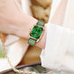 Square quartz watch with green leather strap and gold-tone case, green dial