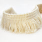Beige cotton tassel lace trim ribbon close-up with dense fringe strands