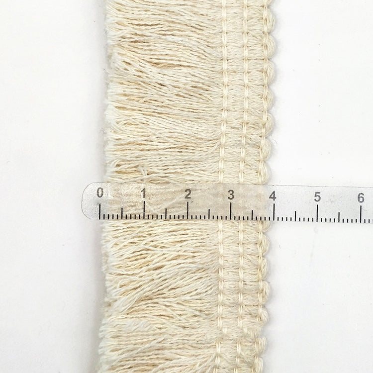 Beige cotton tassel lace trim ribbon with measuring ruler for width indication