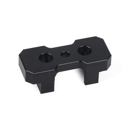 Black transmission mount insert with two mounting holes and center slot