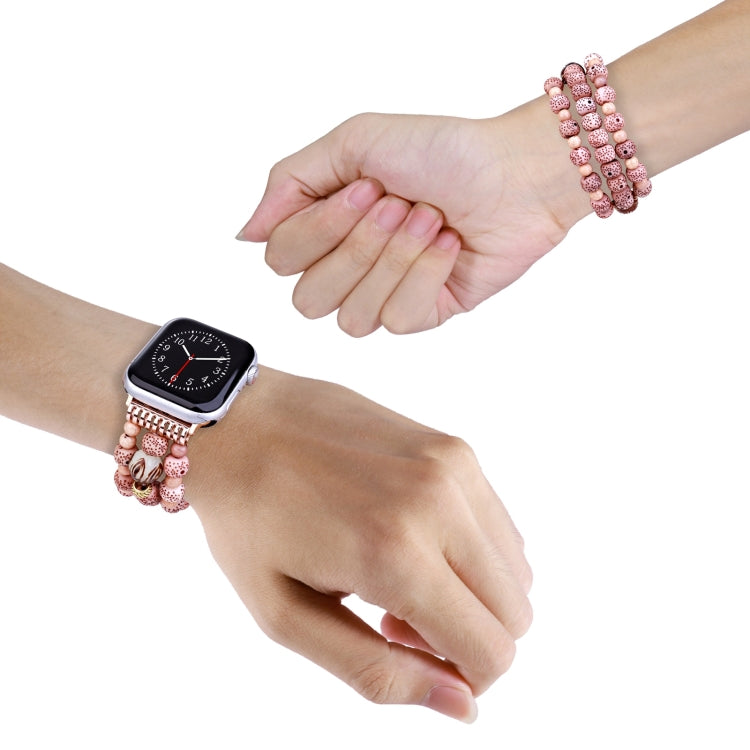 Pink speckled bead watch band on wrist with rose-gold clasp