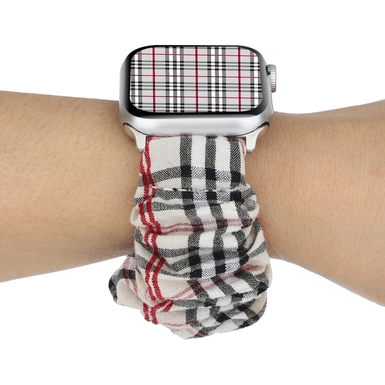 Cloth Apple Watch ring watchband on wrist, black and red plaid fabric