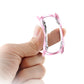 Pink TPU watch case held open by hand, showing protective bezel cutouts