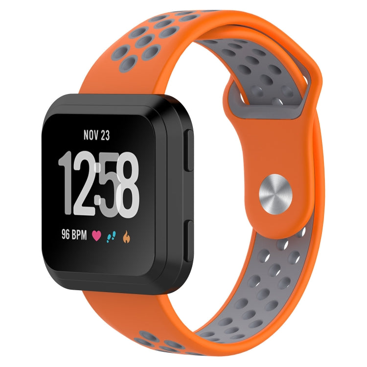 Orange and gray silicone watchband on smartwatch display with black screen and date/time.