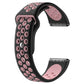 Black and pink two-tone silicone watchband with oval cutouts and silver clasp hardware.