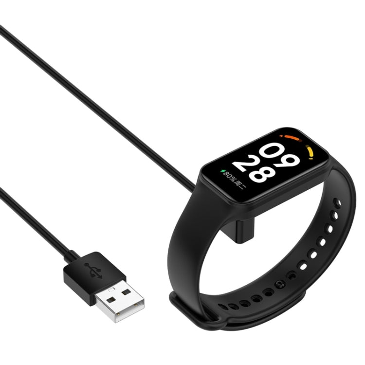 USB charging cable magnetically attached to black smartwatch band