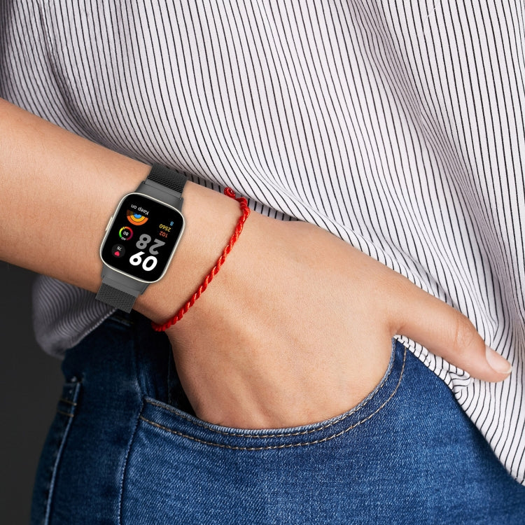 Black milanese metal watch band on wrist, breathable mesh strap with black clasp