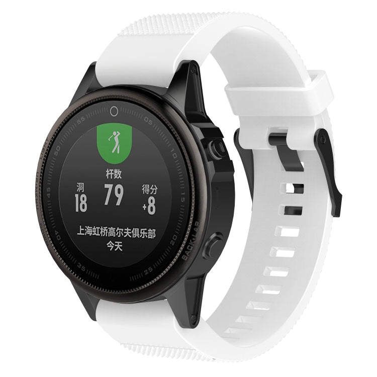 White silicone replacement watch strap with smartwatch attached and quick-release buckle