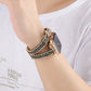 Leather chain watch band worn on wrist, black leather strap with gold-tone links