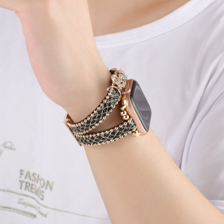 Leather chain watch band worn on wrist, black leather strap with gold-tone links