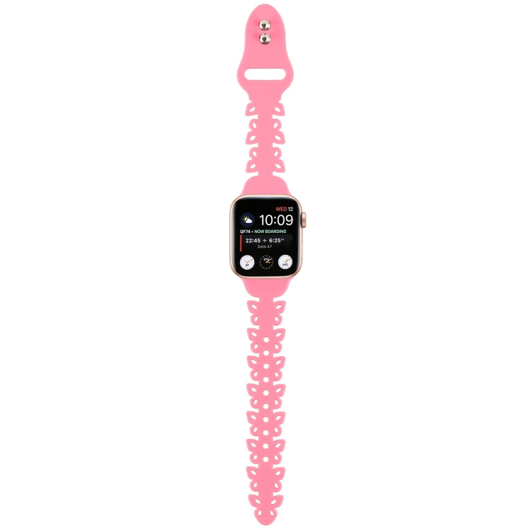 Pink butterfly hollow silicone watch band hanging with small metal pin details.