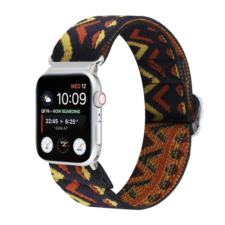 Elastic nylon watch band with buckle, black background with orange and yellow abstract pattern.