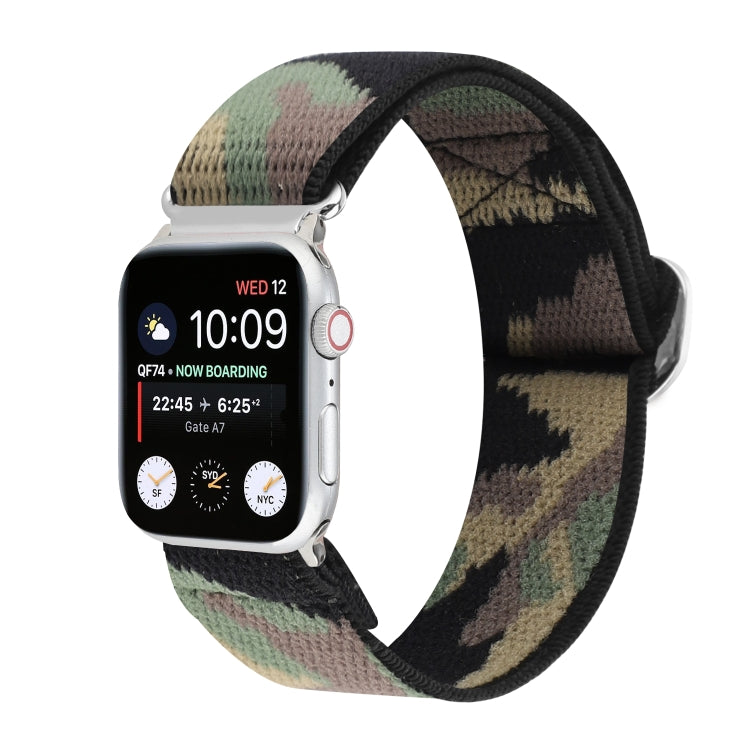 Elastic nylon watch band with abstract pattern in black, green, and gray; metal buckle.