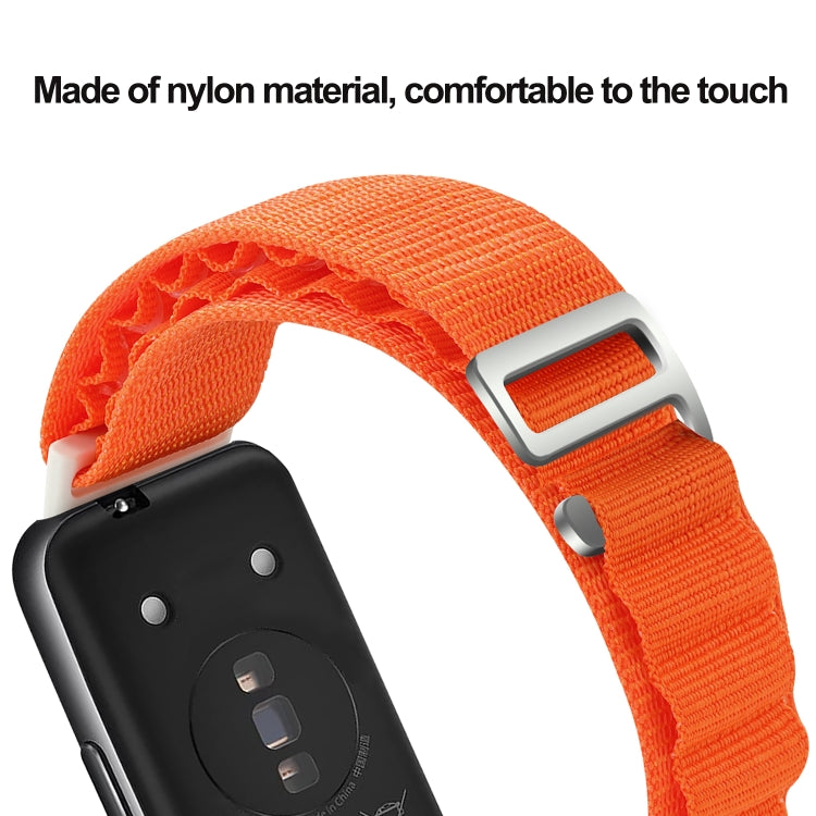 Orange loop nylon watch band close-up with metal buckle and woven texture