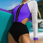 White and purple long-sleeve one-piece swimsuit with black zip and trim