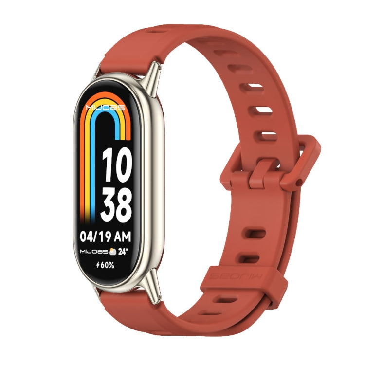 Orange breathable silicone watch band with perforations and metal-toned buckle