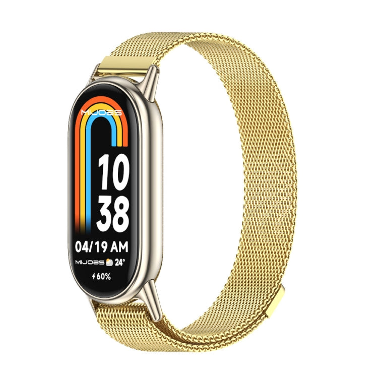 Gold-tone magnetic metal watch band with mesh links, shown with smartwatch display