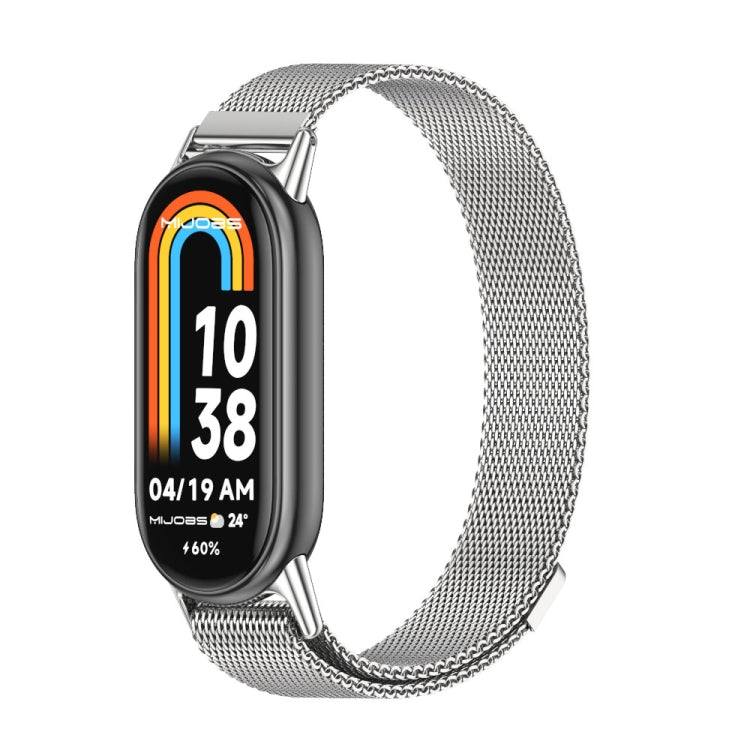 Silver-tone magnetic metal watch band with mesh links, shown with smartwatch display