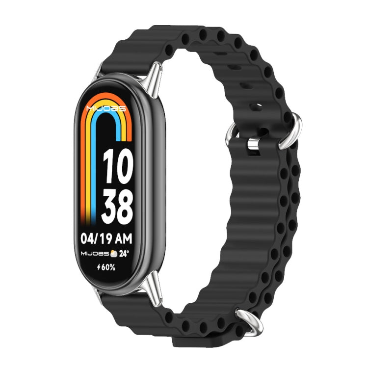 Black breathable silicone watch band with metal clasp and perforated links, watch display visible