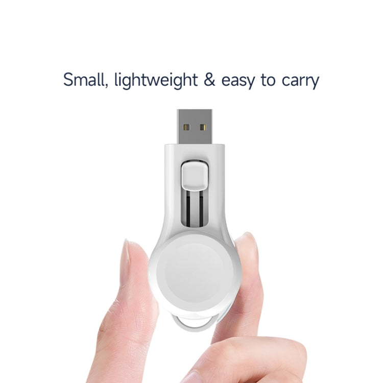 White magnetic suction wireless charger held in hand, showing USB plug