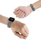 Twist metal watch band with sparkling clear stones on wrist, secure clasp visible.