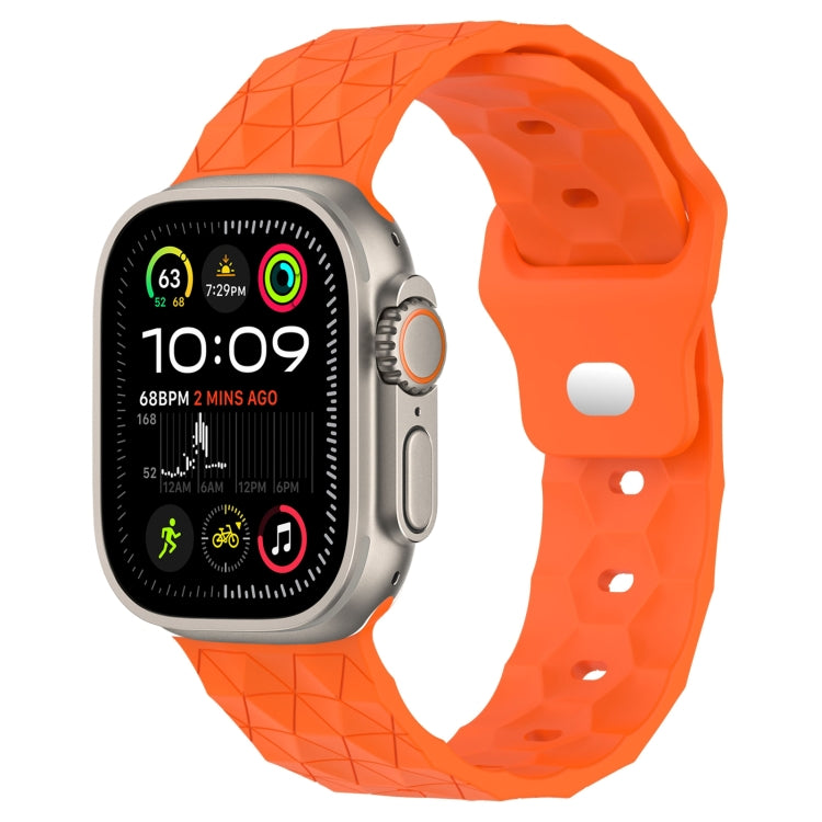 Orange football-texture silicone watch band with perforated holes and raised grid pattern.
