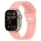 Pink football-texture silicone watch band with perforated holes and textured grip.