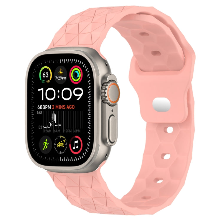 Pink football-texture silicone watch band with perforated holes and textured grip.