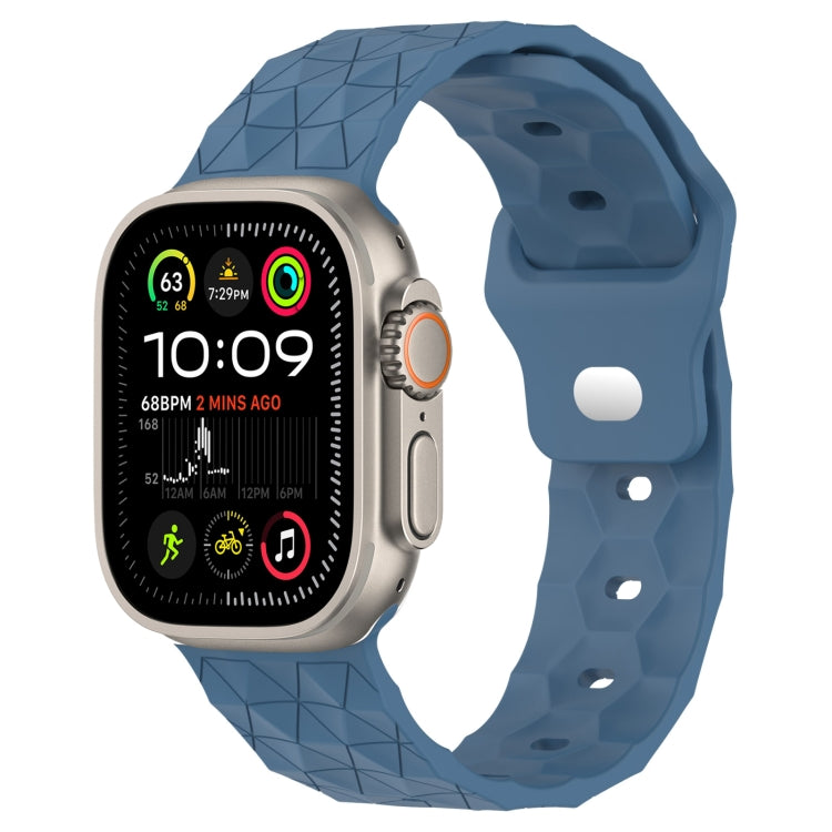 Blue football-texture silicone watch band with geometric pattern and side clasp holes.