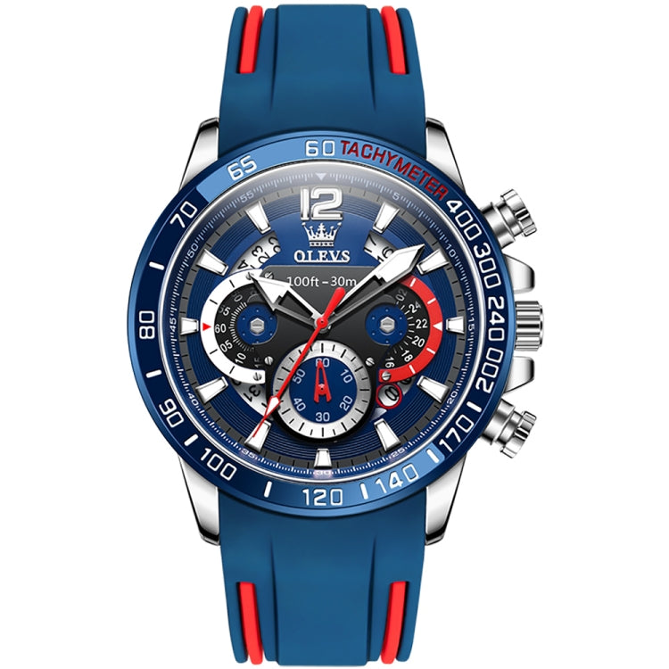 Blue sports quartz chronograph watch with red bezel accents and metal case, silicone strap