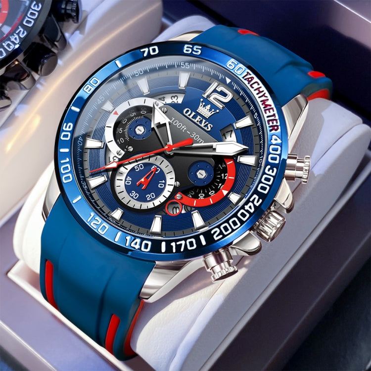 Blue multifunction sports quartz chronograph watch with red detail accents and silver case