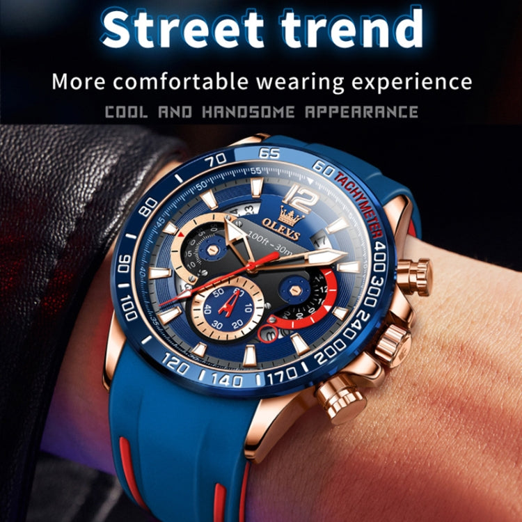 Blue silicone sports quartz chronograph watch on wrist with rose-gold case and silver pushers