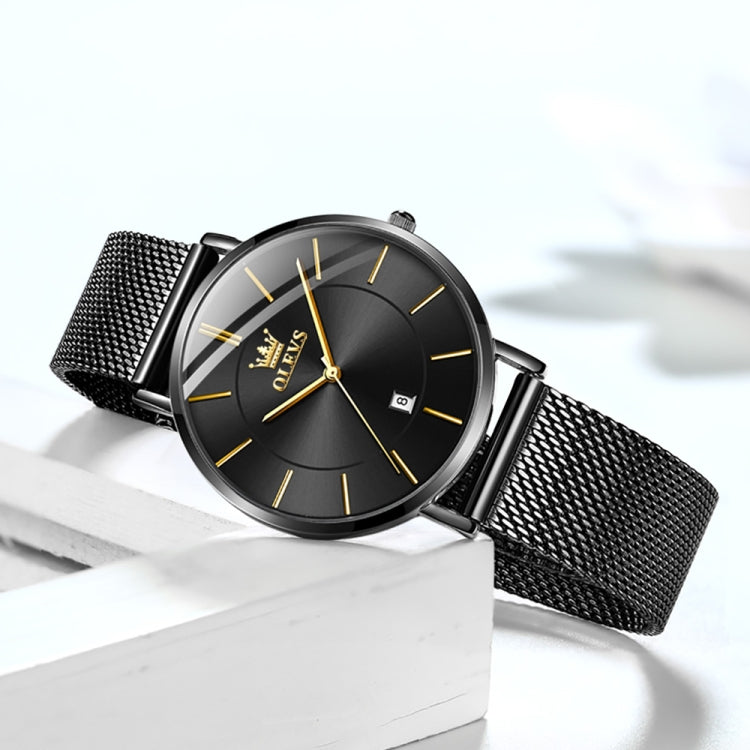 Black dial quartz watch with mesh steel band and gold hands, angled view