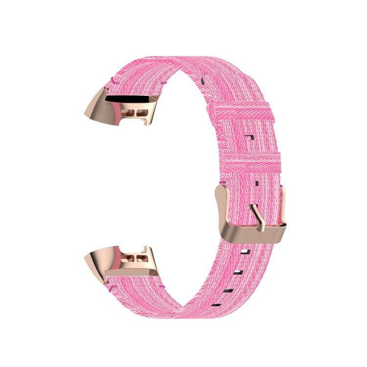 Pink nylon watch strap with rose-gold tone metal clasp and stitched holes detail