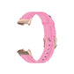 Pink nylon watch strap with rose-gold tone metal connector ends, angle view